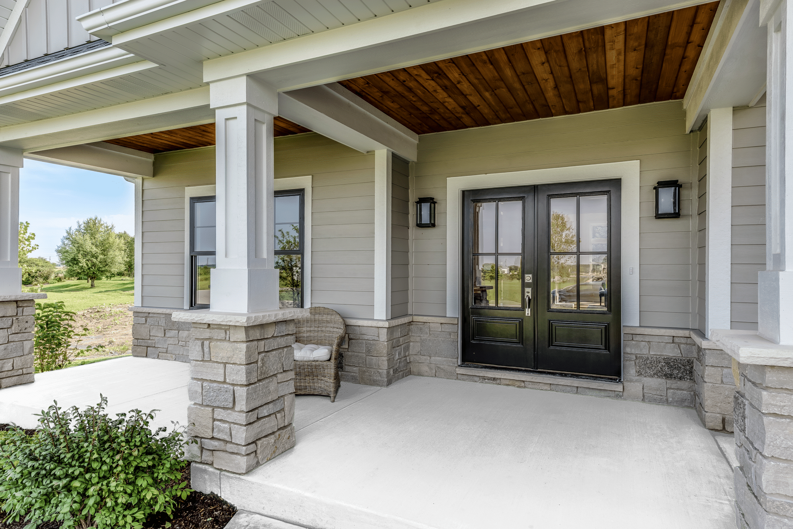 A stone building that has a bench in front of a window