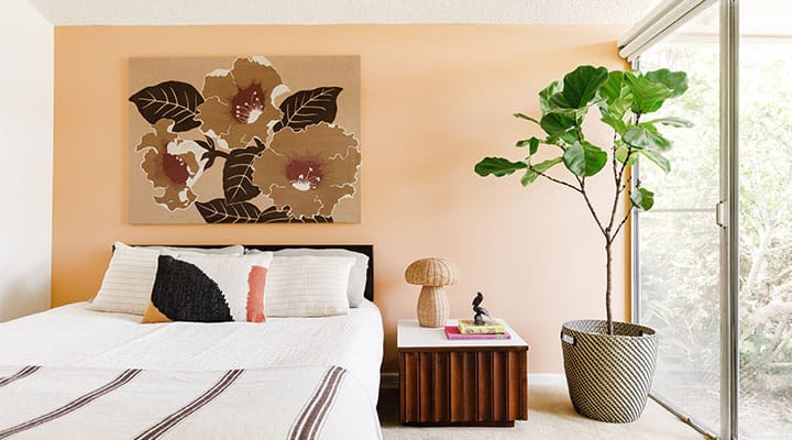 A bed with a lamp on a table