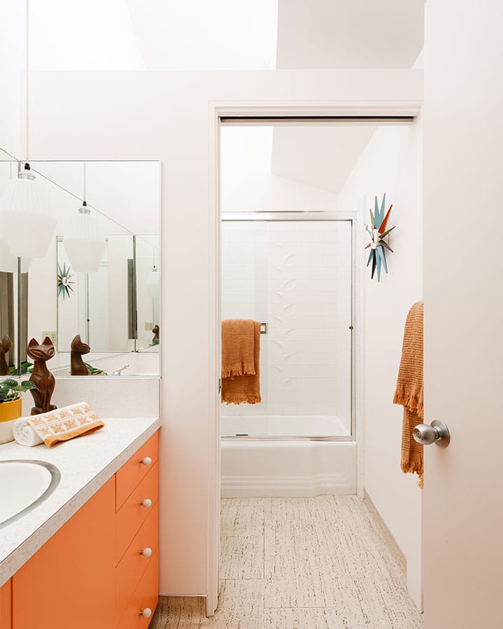 A kitchen with a sink and a mirror