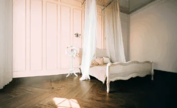 A bedroom with a bed in a room
