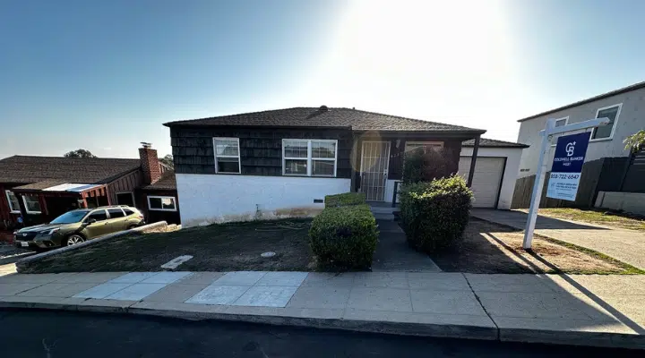 A house that has a sign on the side of a building