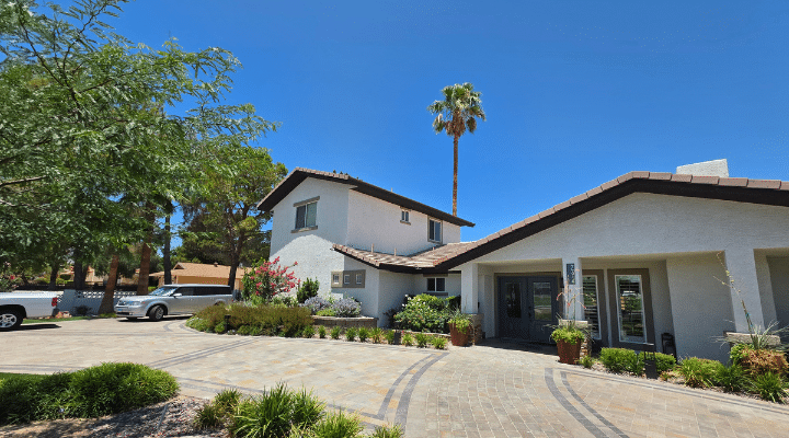 A house that has a sign on the side of a road