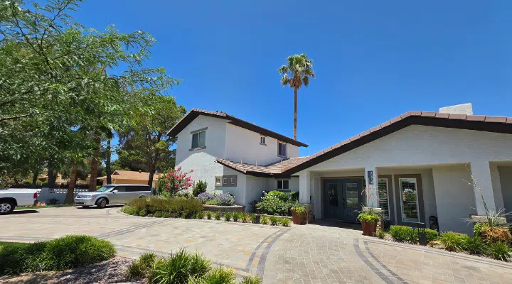 A house that has a sign on the side of a road