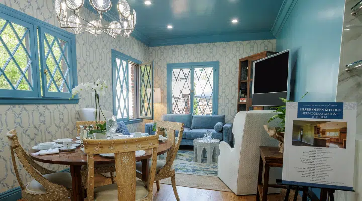 A living room filled with furniture and a fire place and a dining table